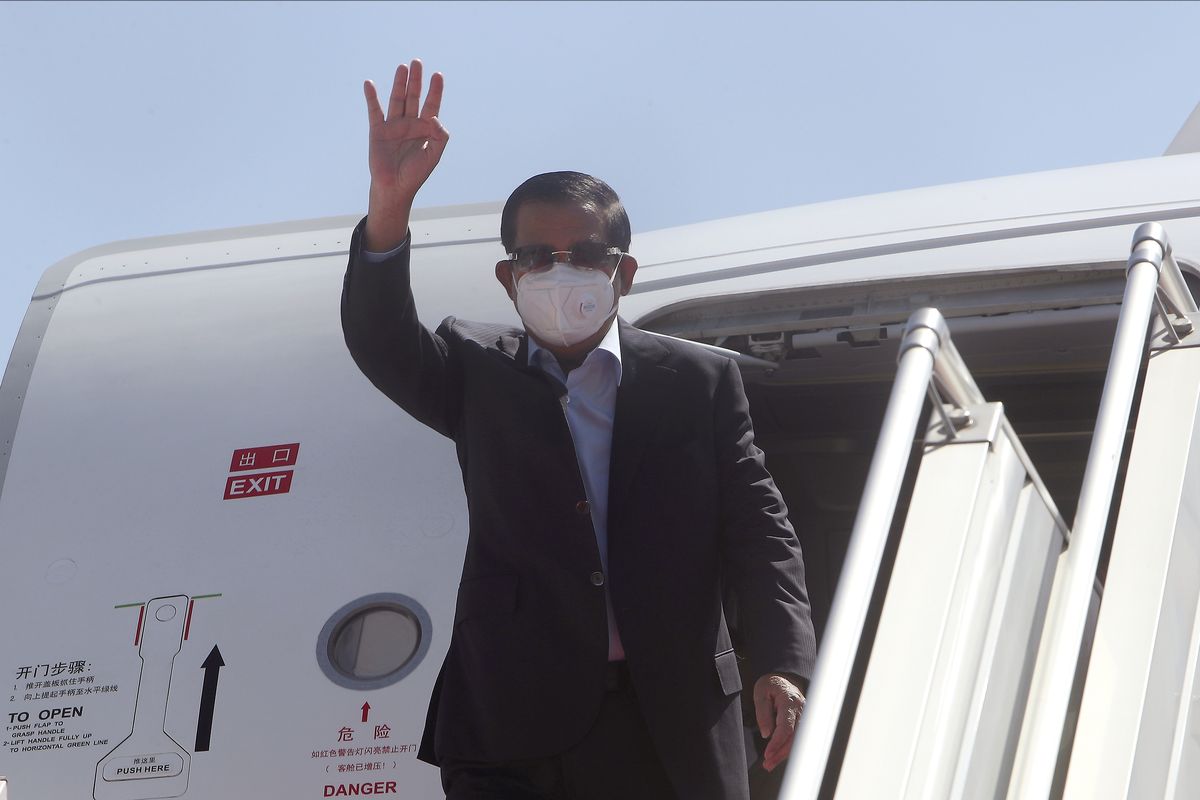 Cambodian Prime Minister Hun Sen waves from a plane upon his arrival from Myanmar, at Phnom Penh International Airport, in Phnom Penh, Cambodia, Saturday, Jan. 8, 2022. Prime Minister Hun Sen