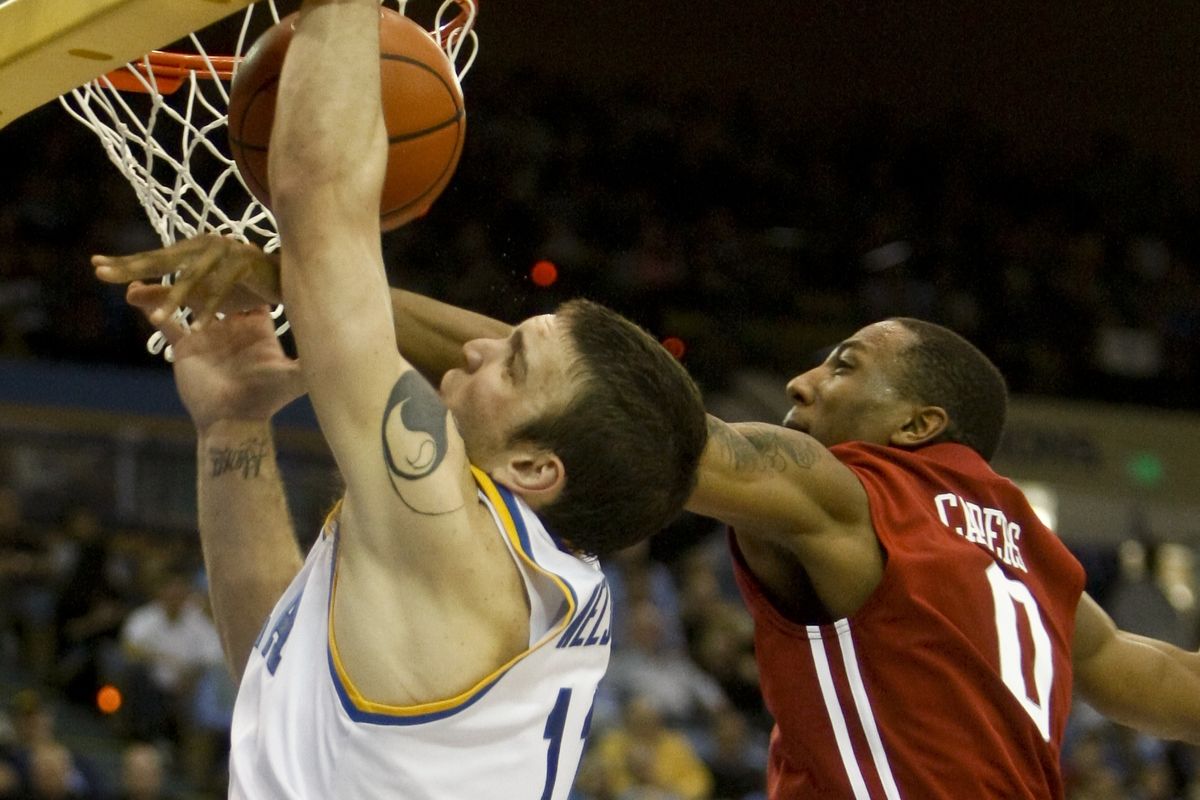 UCLA forward Reeves Nelson is fouled by Washington State guard Marcus Capers during the second half.   (Associated Press / Fr139655 Ap)