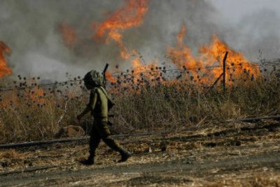 
An Israeli soldier passes an artillery range after a Hezbollah rocket barrage struck the area near Kiryat Shmona, Israel, on Sunday. 
 (Associated Press / The Spokesman-Review)