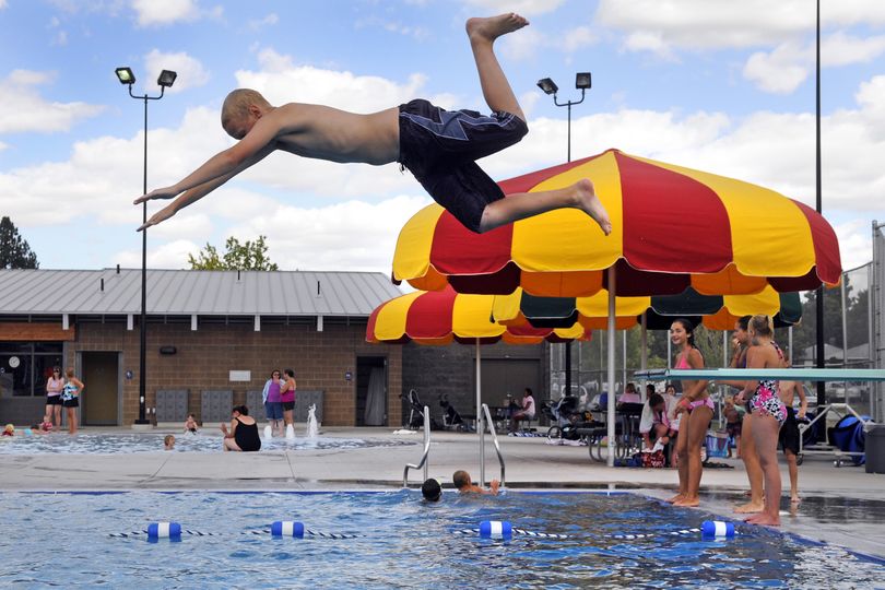 Jamie Erickson, 13, of Deer Park, shows his form off the diving board while spending Tuesday afternoon at the Shadle Aquatic Center Pool in Spokane. It was his first time this summer to the pool. City pools close for the season on Saturday. (Dan Pelle)