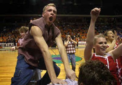 
Brian Hutchinson and Julie Kimball do their best to raise the volume of the Ferris High School fans during Friday's Rubber Chicken girls basketball game against Lewis and Clark. 
 (Jed Conklin / The Spokesman-Review)