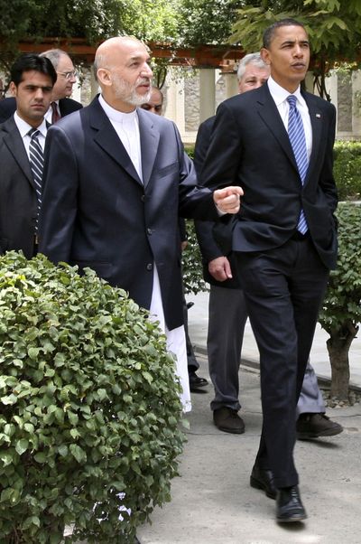 Barack Obama walks with Afghan President Hamid Karzai on the grounds of the Presidential Palace in Kabul on Sunday.  (Associated Press / The Spokesman-Review)