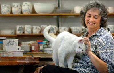 
Donna Kulibert and her cat, Sugar, take a break in her Medical Lake pottery studio.
 (Photos by INGRID BARRENTINE/ / The Spokesman-Review)