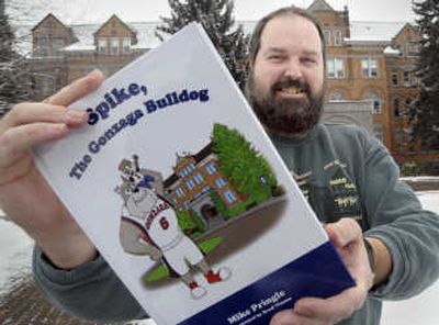 
Gonzaga University associate English professor Michael Pringle stands outside the Administration Building on the GU campus Tuesday with his children's book 
