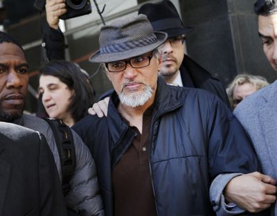 This March 9, 2017,  photo shows Ravi Ragbir, executive director of the New Sanctuary Coalition, being escorted by supporters after his annual check-in with Immigration and Customs Enforcement, in New York. (Seth Wenig / Associated Press)