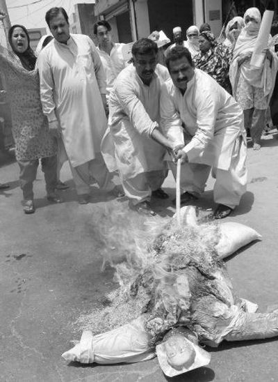 
Activists of a Pakistani opposition party burn an effigy of President Gen. Pervez Musharraf during a  rally in Multan, Pakistan, on Sunday. 
 (Associated Press / The Spokesman-Review)