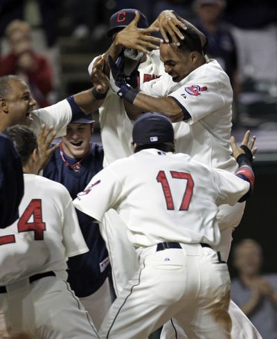 Cleveland’s Luis Valbuena, top right, is congratulated after hitting a game-winning solo home run in the 11th. (Associated Press / The Spokesman-Review)