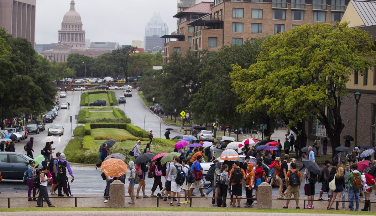 University of Texas students stand outside after evacuating buildings at The University of Texas on Friday, Sept. 14, 2012 in Austin, Texas. Thousands of people streamed off university campuses in Texas and North Dakota on Friday after phoned-in bomb threats prompted evacuations and officials warned students and faculty to get away as quickly as possible. No bombs were found on either campus by early afternoon and it was not clear whether the threats were related. (Ricardo B.brazziell / Austin American-statesman)