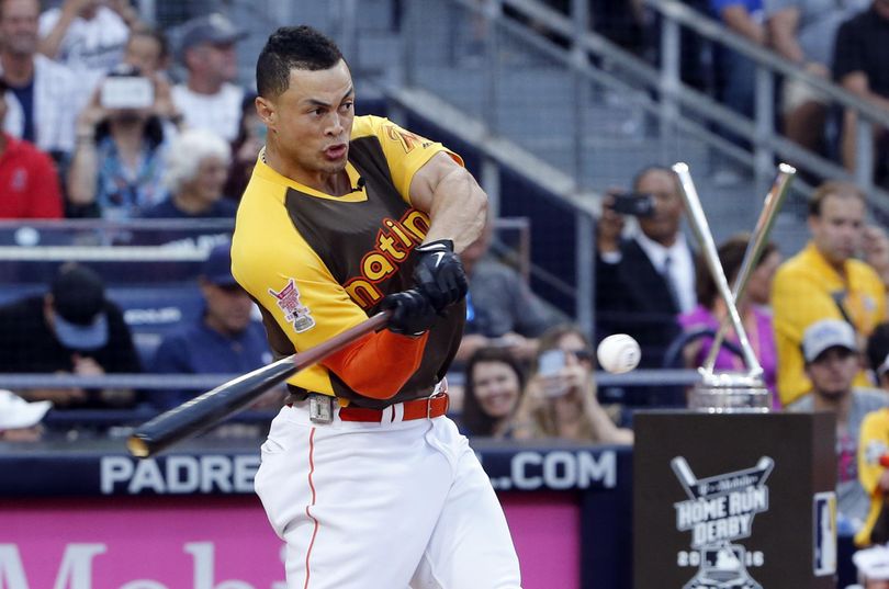 Giancarlo Stanton, of the Miami Marlins, rips one of his 61 homers on his way to winning the Home Run Derby. (Lenny Ignelzi / Associated Press)