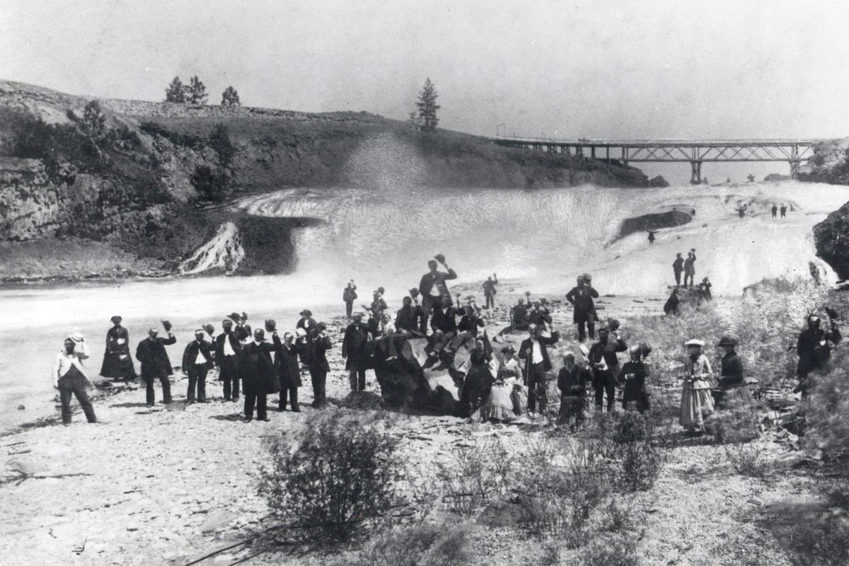 1889: A group of unidentified early settlers poses for a picture on the flats below the Spokane Falls in the area that is now Huntington Park.