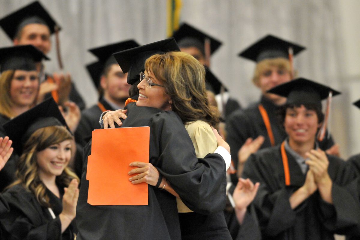 Former Alaska Gov. Sarah Palin hugs Republic High graduate Tyler Weyer, who introduced her and helped organize the invitation for her to speak at Saturday’s graduation. The event drew Palin fans from around the region and was a major coup for the graduates who wooed her as a commencement speaker. (Jesse Tinsley)