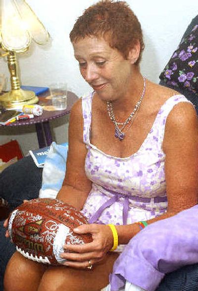 
Cathy Mazurkiewicz examines an autographed Notre Dame football. 
 (Associated Press / The Spokesman-Review)