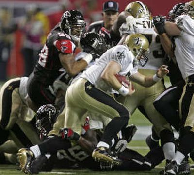 
Quarterback Drew Brees is stopped here, but led New Orleans past Atlanta. Associated Press
 (Associated Press / The Spokesman-Review)
