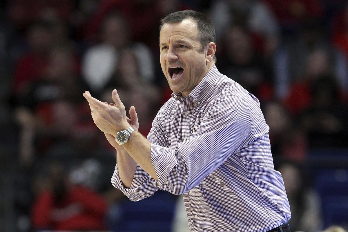 Louisville coach Jeff Walz urges his team on during the second half of an NCAA women