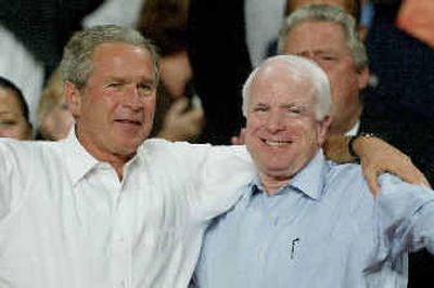 
President Bush and Sen. John McCain, R-Ariz., share a half-hug at the Pensacola Civic Center for a Bush rally Tuesday in Pensacola, Fla.
 (Associated Press / The Spokesman-Review)
