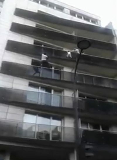 In this Saturday, May 26, 2018 grab taken from UGC video, Mamoudou Gassama scales an apartment building to save a young child dangling from a balcony, in Paris. (Associated Press)