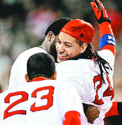 Julio Lugo (23) and David Ortiz greet Manny Ramirez, right, after his homer in the eighth snapped a 7-all tie in Boston's 8-7 win over Seattle.
(Associated Press / The Spokesman-Review)