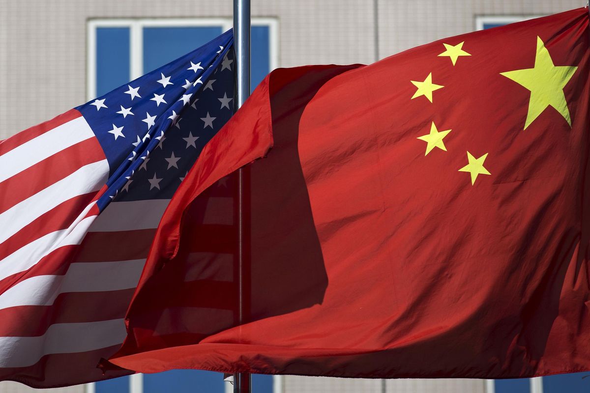 In this Sept. 5, 2012, file photo, U.S. and China’s national flags flutter in winds at a hotel in Beijing. China has denied an accusation by U.S. President Donald Trump that it hacked the emails of Hillary Clinton, his Democratic opponent in the 2016 election. (Andy Wong / Associated Press)