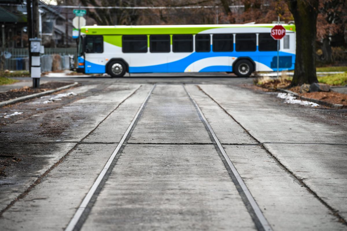 An STA bus heads west on 14th Avenue past old streetcar rails on Madison Street in Spokane.  (DAN PELLE/THE SPOKESMAN-REVIEW)