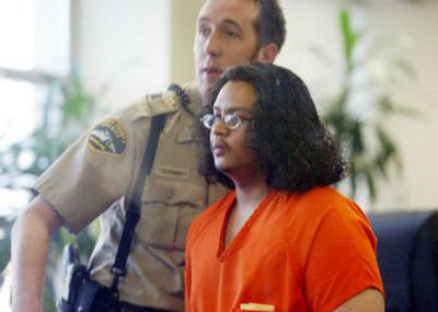 
Douglas Chanthabouly, 18, right, is led out of a courtroom Thursday  in Tacoma. Chanthabouly is accused of  killing a fellow student Wednesday. 
 (Associated Press / The Spokesman-Review)