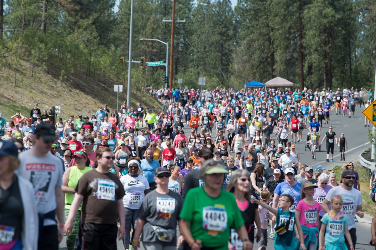 The Bloomsday throng makes its way down Whistalks Way to the T.J. Meenach Bridge over the Spokane River before turning up Pettet Drive, also known as Doomsday Hill in this May 2019 photo. (JESSE TINSLEY)