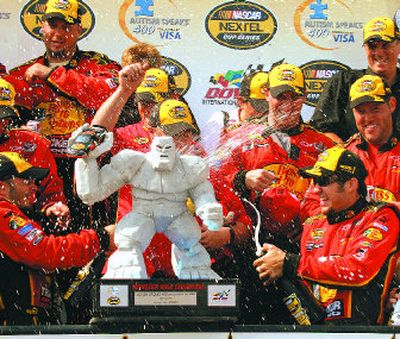 
Martin Truex Jr., lower right, celebrates winning the Autism Speaks 400 auto race with his crew in victory lane at Dover.
 (Associated Press / The Spokesman-Review)