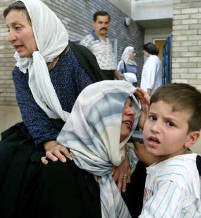 An Iraqi boy comforts his mother at Baghdad's Al Numan hospital after she learned that one of her relatives died after a car bomb exploded in Baghdad on Wednesday, killing at least four people and injuring dozens, police said. An Iraqi boy comforts his mother at Baghdad's Al Numan hospital after she learned that one of her relatives died after a car bomb exploded in Baghdad on Wednesday, killing at least four people and injuring dozens, police said.
(Associated PressAssociated Press / The Spokesman-Review)