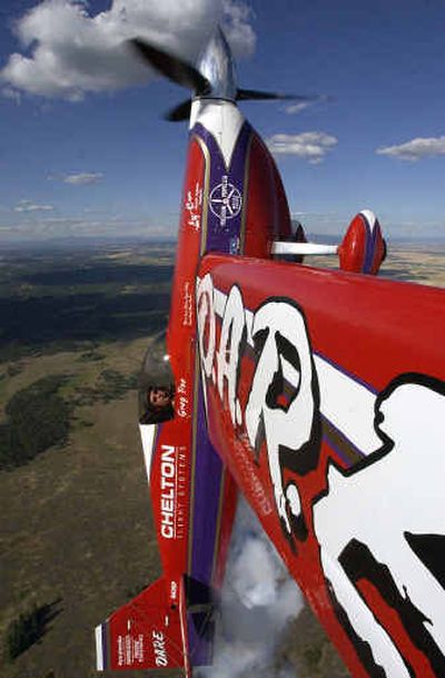 
Skyfest performer Greg Poe takes his D.A.R.E Edge 540 custom-designed aerobatic airplane to vertical  on Wednesday. With a photographer's camera mounted on his wing, Poe took this photograph while soaring high above Spokane County. 
 (Jed Conklin / The Spokesman-Review)