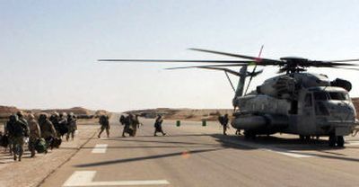 
In this picture released by U.S. forces, Marines board a helicopter at Al Asad Airbase, Iraq, in preparation for Operation Steel Curtain that began in the early hours of Saturday morning. 
 (Associated Press / The Spokesman-Review)