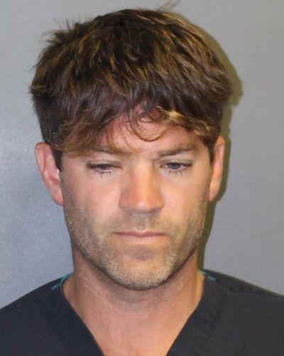 This undated booking photo provided by the Newport Beach, Calif., Police Department shows Grant W. Robicheaux, 38, a California doctor who appeared in a reality TV dating show. He and a woman co-defendant, Cerissa Laura Riley, 31, have been charged with drugging and sexually assaulting two women, and authorities suspect there may be many more victims. (Associated Press)