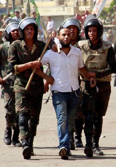 Soldiers detain a man during an operation to clear protesters from Tahrir Square in Cairo on Monday. Egyptian troops wielding electric batons clashed with protesters camping out to press demands for change. (Associated Press)