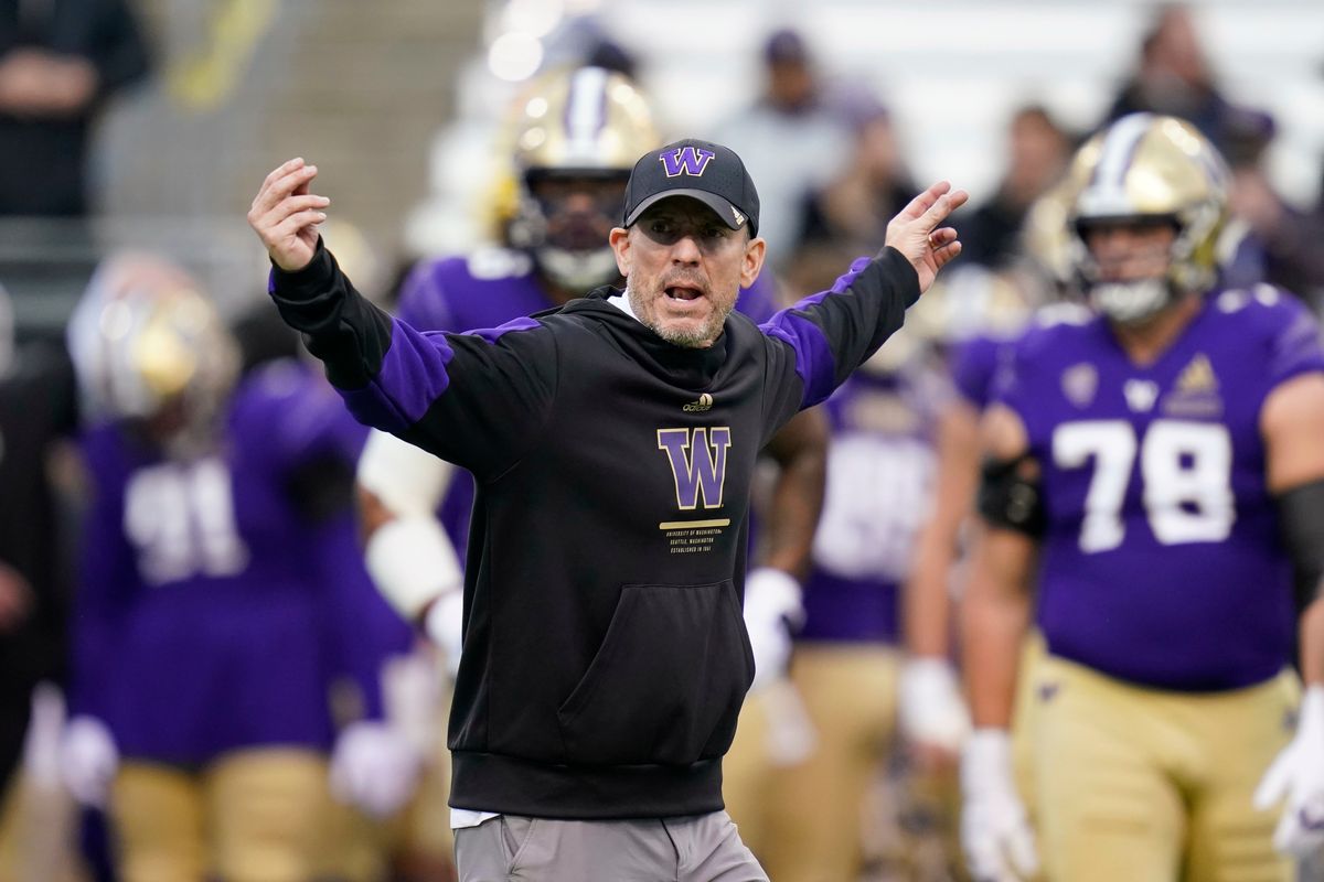 Washington acting coach Bob Gregory directs players before an NCAA college football game against Arizona State on Saturday, Nov. 13, 2021, in Seattle.  (Elaine Thompson)
