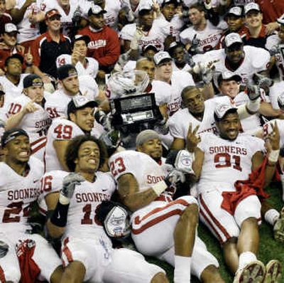 
Oklahoma poses with the Big 12 Conference championship trophy Saturday after beating Missouri. Associated Press
 (Associated Press / The Spokesman-Review)