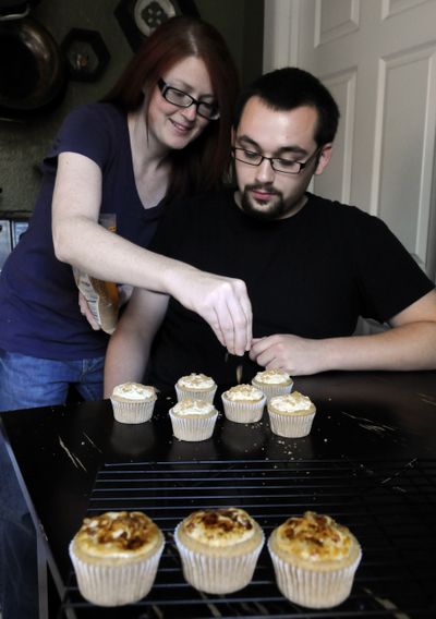 Jackie Mustard sprinkles brown sugar on Creme Brulee cupcakes that she and Dylan Waidelich made with Southern Tier Brewing Co. Imperial Stout in their kitchen. (J. Bart Rayniak)