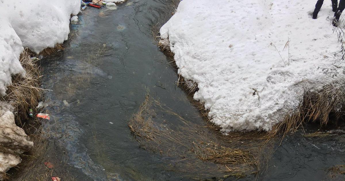 Driver walks away after car lands upside down in creek