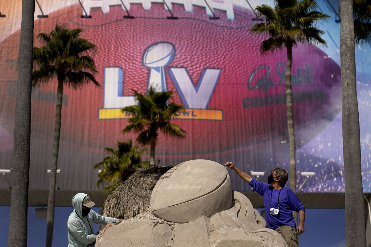 FILE - In this Feb. 4, 2021, file photo, workers sculpt the Lombardi Trophy out of sand outside of Raymond James Stadium ahead of Super Bowl 55 in Tampa, Fla. The city is hosting Sunday