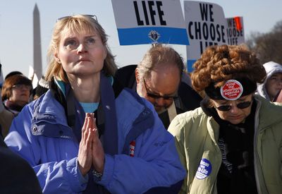Abortion opponents pray at a rally on the National Mall in Washington on Thursday before marching to the Supreme Court.  (Associated Press / The Spokesman-Review)