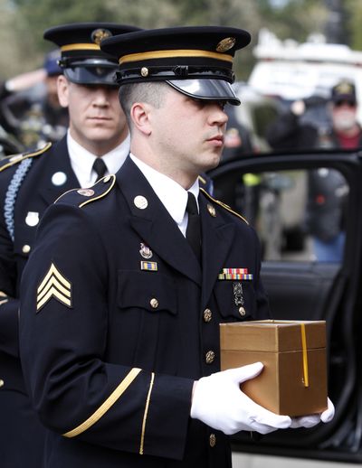 A soldier carries the remains of Peter Knapp during his military funeral Friday. (Associated Press)