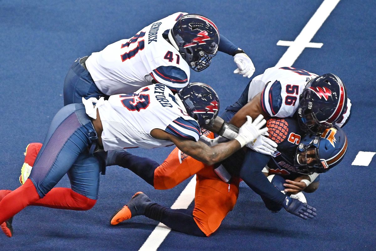 Spokane Shock quarterback Blake Sims (6) is gang tackle for a lose by Sioux Falls Storm during a IFL game Saturday, July 10, 2021 at Spokane Arena in Spokane WA.   (James Snook For The Spokesman-Review)
