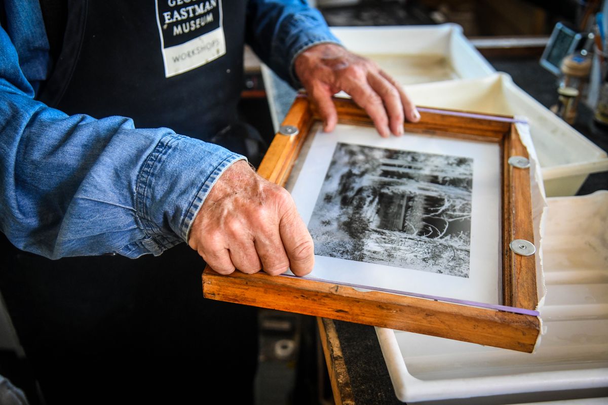 Greg Roth places a negative into a print frame to make a salt print.  (Dan Pelle/THESPOKESMAN-REVIEW)
