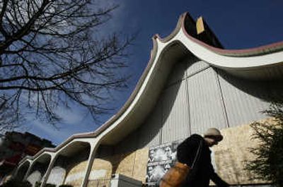 
Jeannett Bugay walks by the former Manning's Cafeteria/Denny's restaurant building  in Ballard, Wash., on  Feb. 20. The Seattle Landmark Preservation Board has designated the building as a landmark, blocking a plan to replace it with an eight-story development. Associated Press
 (Associated Press / The Spokesman-Review)