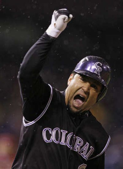 
Colorado's Yorvit Torrealba reacts after hitting a tie-breaking three-run home run during the sixth inning in Game 3 of the National League Championship Series against Arizona.Associated Press
 (Associated Press / The Spokesman-Review)