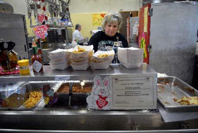 
Lunch lady Denise Brown gets ready for the next wave of students between lunches at Rogers High School in Spokane. 
 (Holly Pickett / The Spokesman-Review)