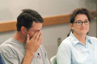 
Paul Herr Jr., son of Paul Herr, wipes a tear from his eye during a news conference as he says thanks to the search and rescue units that found and transported his father to the hospital Wednesday after his plane crashed near Kooskia, Idaho, on Monday. At right is the elder Herr's wife, Christine, of Pasco. 
 (Associated Press / The Spokesman-Review)