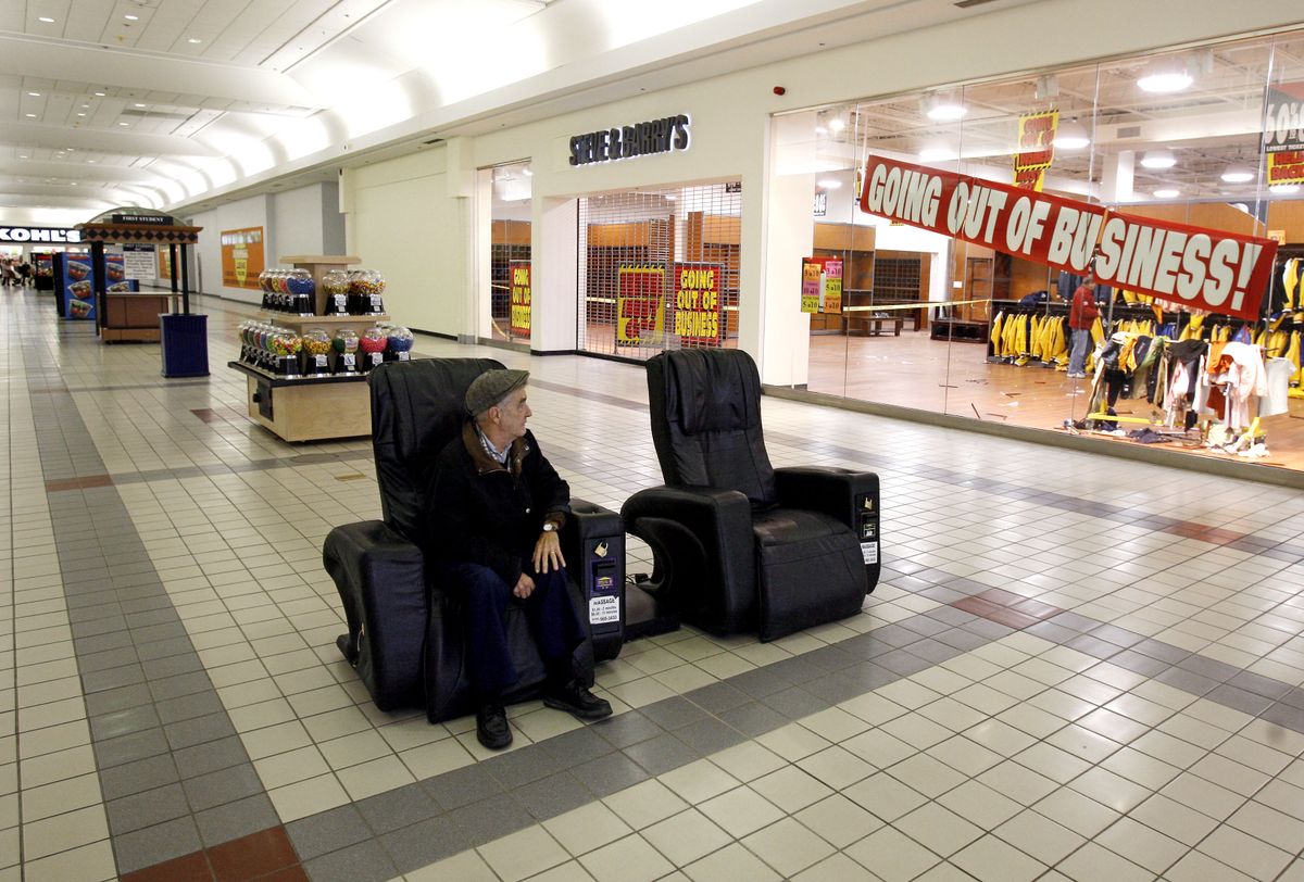 Tom Lucet, of Beverly, Mass., sits alone outside a Steve & Barry’s at the Liberty Tree Mall in Danvers, Mass. The cutback in consumer spending has been a result of the deteriorating job market. Associated Press photos (Associated Press photos / The Spokesman-Review)