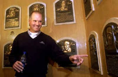 
Former Chicago Cubs second baseman Ryne Sandberg points to a plaque adorning the wall at the Baseball Hall of Fame in Cooperstown, N.Y., on Tuesday. 
 (Associated Press / The Spokesman-Review)