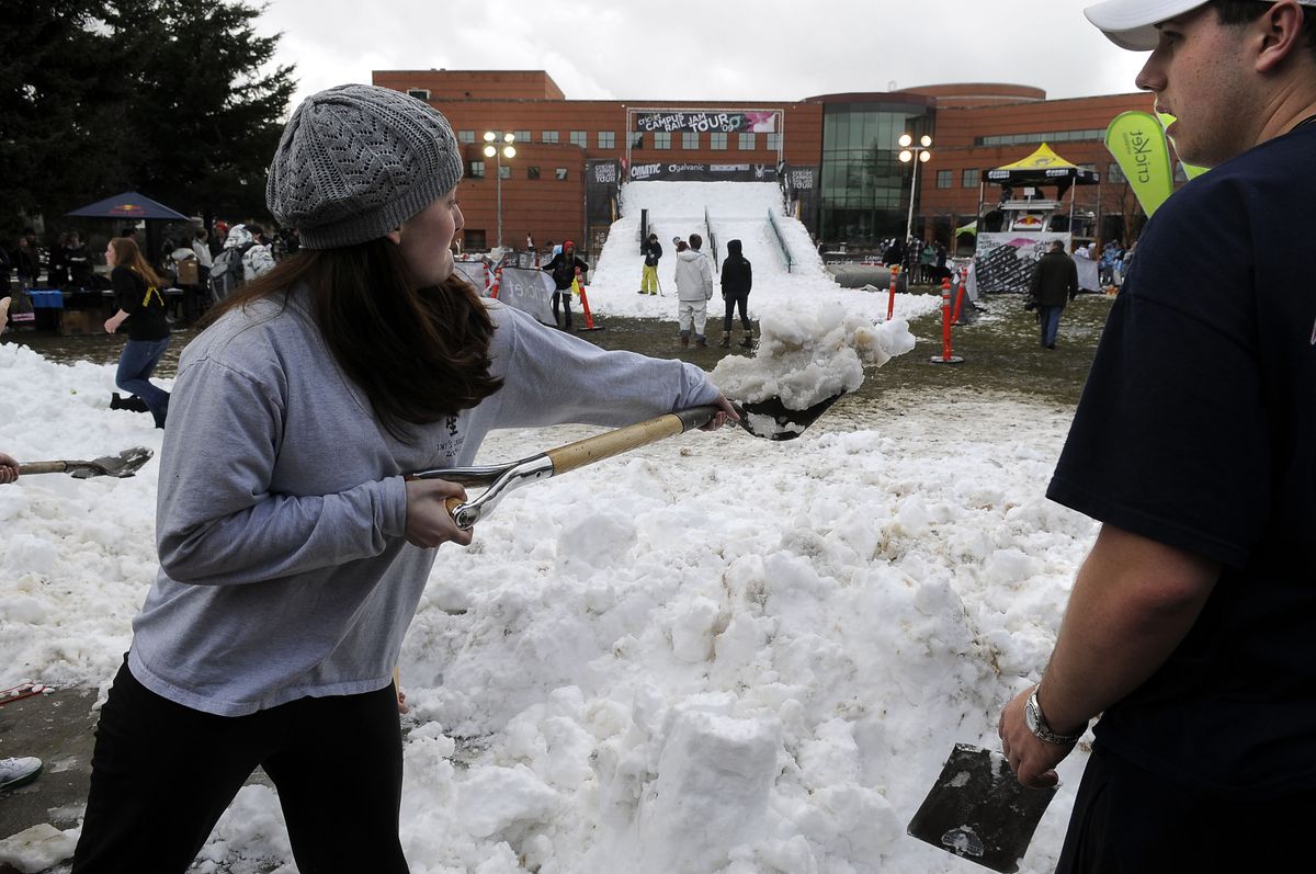 Gonzaga University students help shovel snow away from a walkway near the competition area of the Cricket Wireless Campus Rail Jam on Thursday.  (Dan Pelle / The Spokesman-Review)