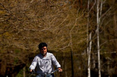 
North Idaho College English professor Bob Bennett rides his bike around the campus in Coeur d'Alene on Thursday. Bennett rides his bike to work nearly every day. 
 (Kathy Plonka / The Spokesman-Review)