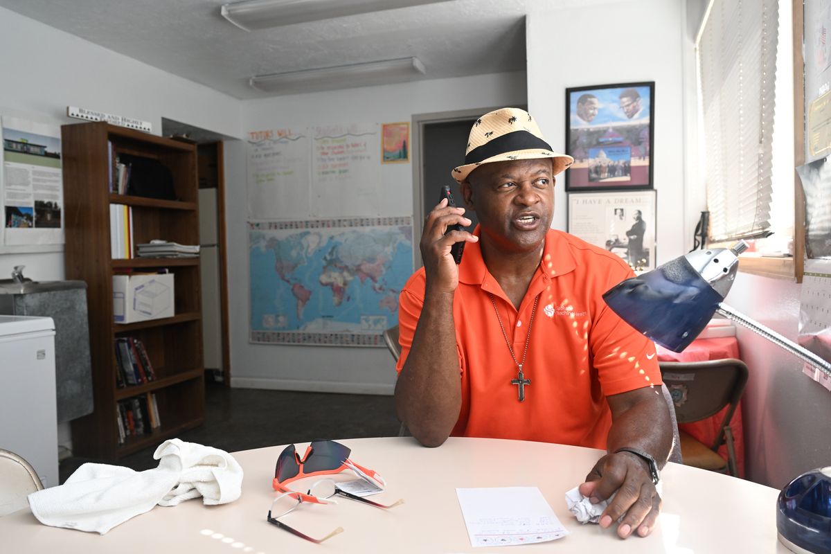 Michael Brown talks on the phone as he sits in the office at the Spokane Eastside Reunion Association youth center in East Spokane Monday, July 8, 2024. Brown is the driving force behind the Association, organizing the annual basketball camp for kids and running the Fresh Soul restaurant next door, which is also a job training program for area youth.  (Jesse Tinsley/THE SPOKESMAN-REVIEW)