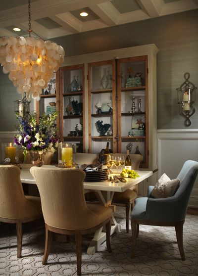 A shell chandelier inspired by nature in a coastal dining room.